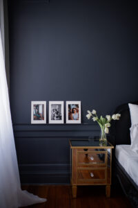 Professional boudoir photography prints featured on a black wall at Black Lace Boudoir luxury studio.