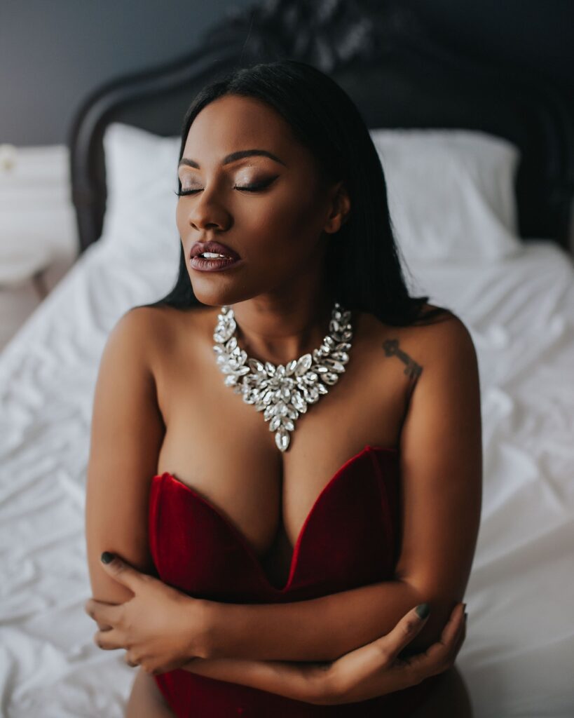 Luxury Boudoir photoshoot of black woman wearing necklace. 