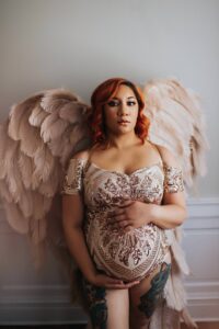 best maternity boudoir studio, Black Lace Boudoir, Washington D.C. with client posing at studio wearing pink angel wings.