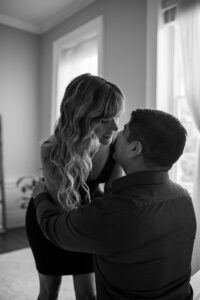 Black Lace Boudoir couples boudoir session featuring black and white photo of a couple smiling at each other.