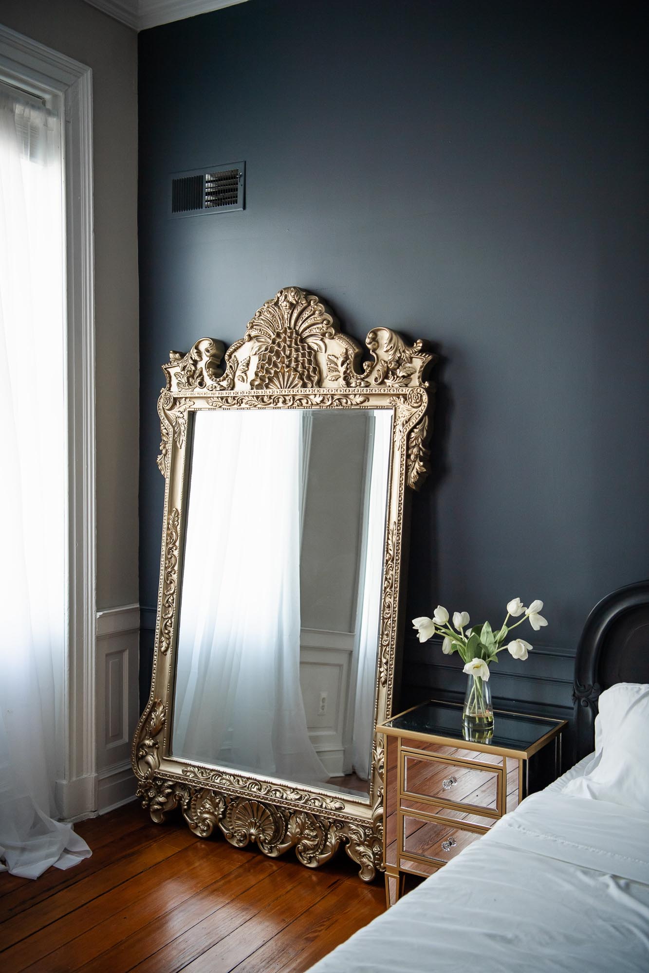 Boudoir studio in Virginia featuring bedroom set with luxury mirror and decor.