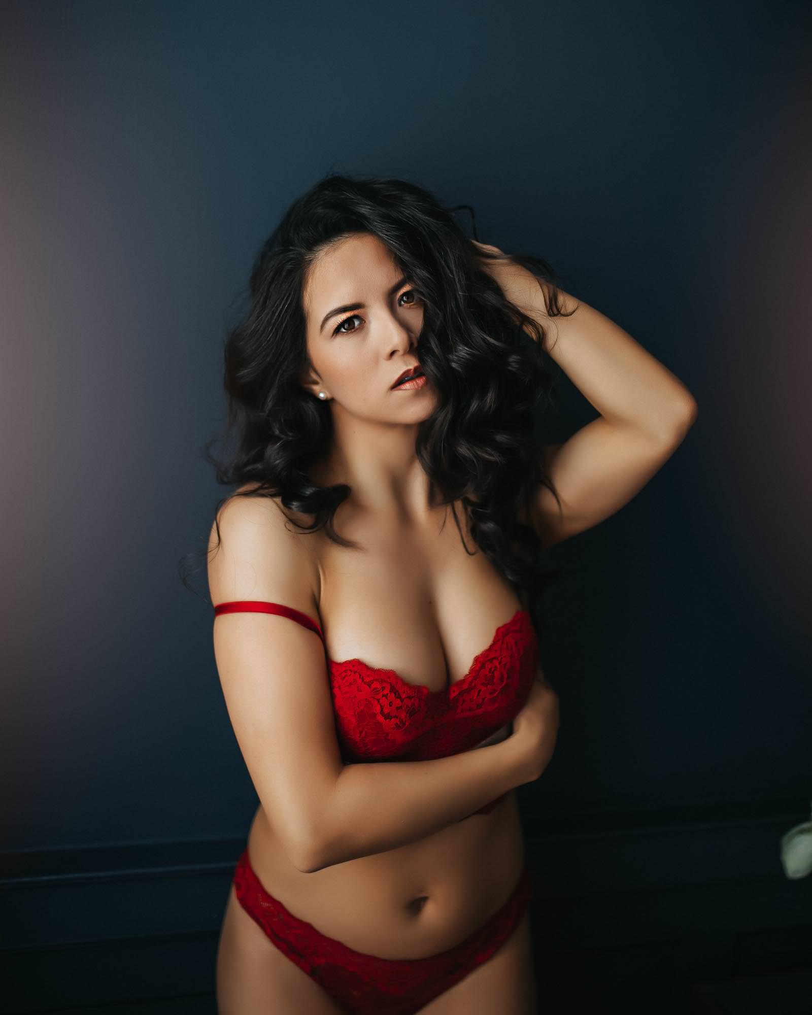Boudoir studio photoshoot of a woman wearing red undergarments.
